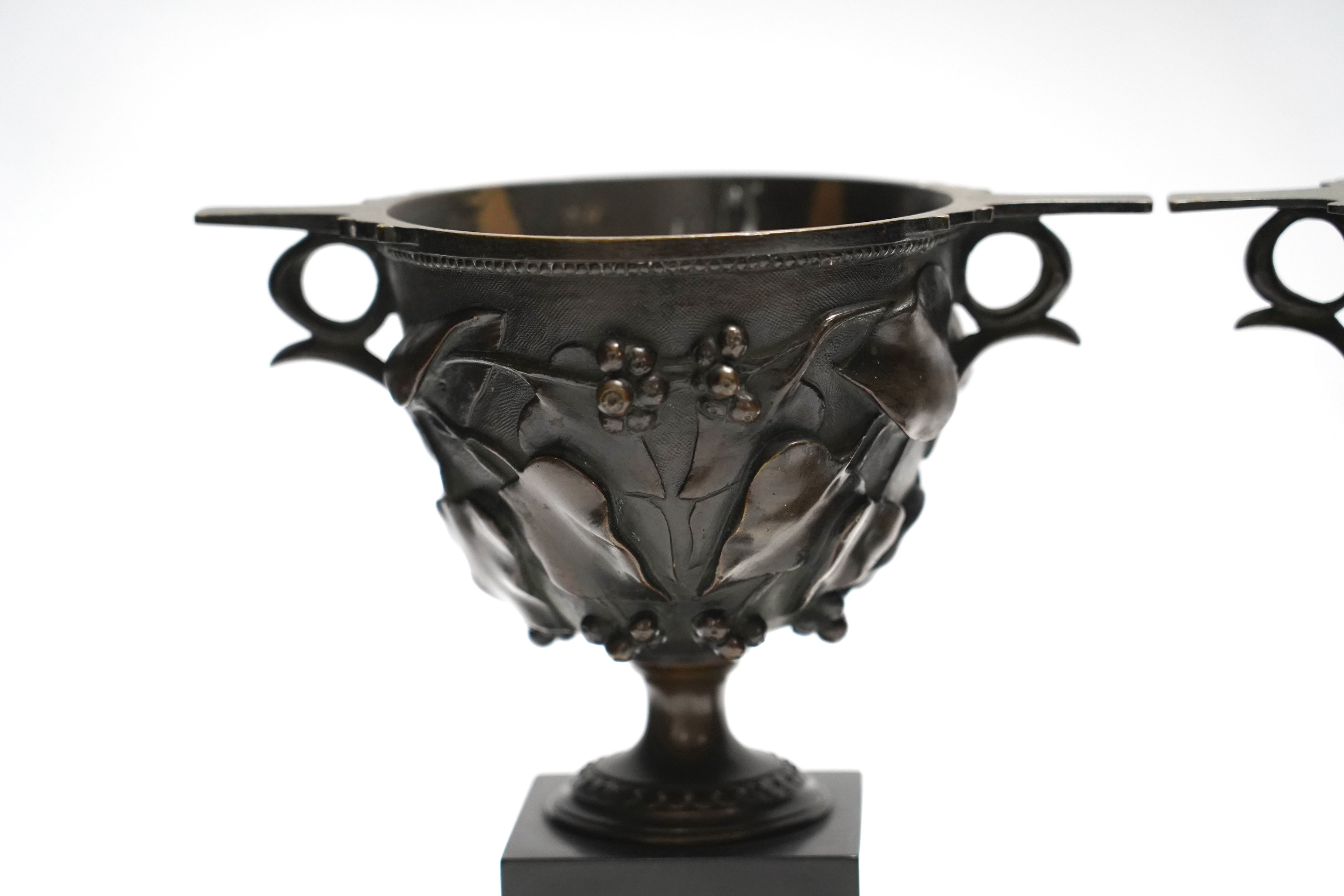 After the Antique, a pair of late 19th century bronze skyphos vessels on polished slate bases, 22cm